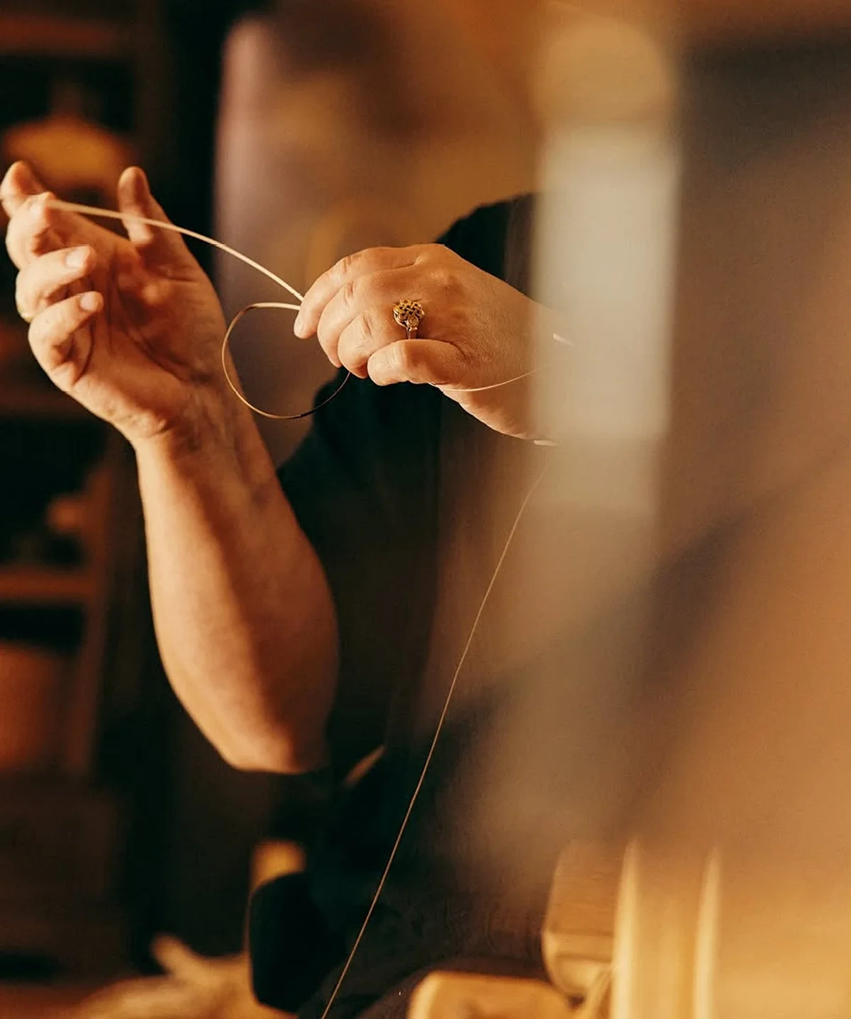 Artisan hand-stitching a piece of leather