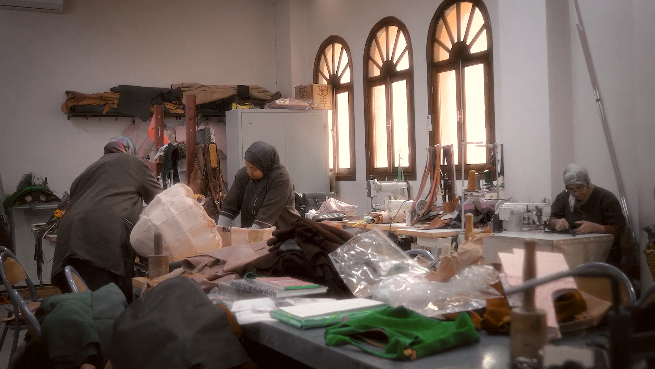 Women artisans working together in a Moroccan leather workshop
