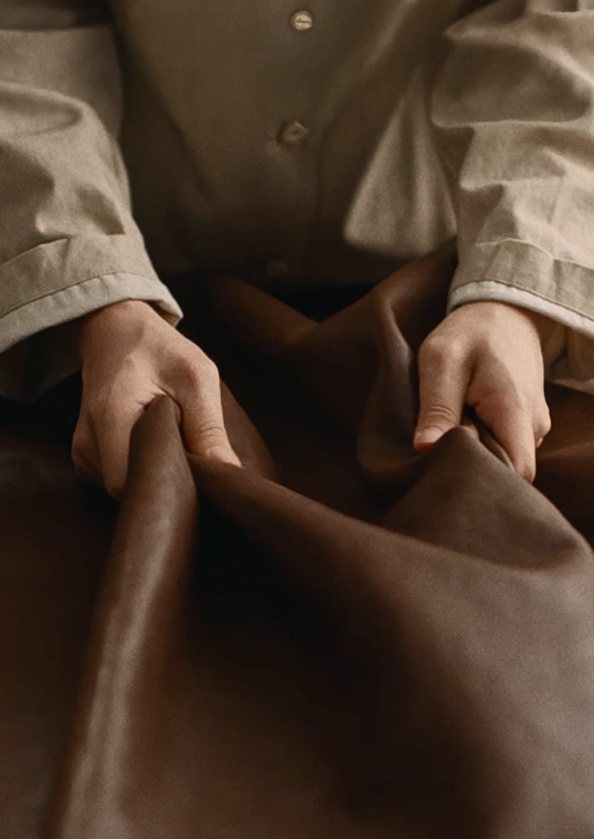Artisan preparing leather pieces by hand